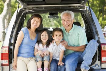 Royalty Free Photo of a Couple With Grandkids in a Hatchback