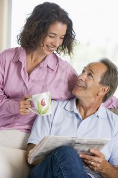 Royalty Free Photo of a Couple Relaxing With a Newspaper