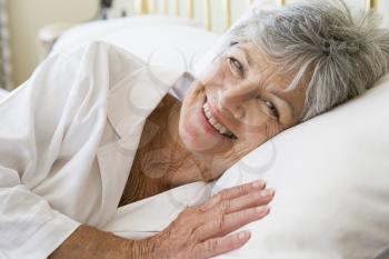Royalty Free Photo of a Woman Smiling in Bed