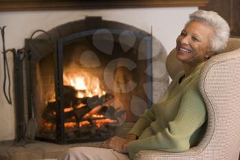 Royalty Free Photo of a Woman Beside a Fireplace