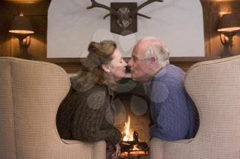 Royalty Free Photo of a Couple Beside a Fireplace