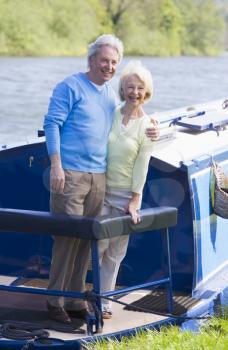 Royalty Free Photo of a Couple With a Boat