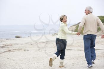 Royalty Free Photo of a Couple Running at the Beach