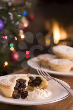 Royalty Free Photo of Mince Pies With a Christmas Tree and Fireplace in the Background