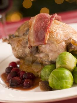 Royalty Free Photo of a Roast Partridge Potato Cake,  Brussels Sprouts and Cranberry Jus