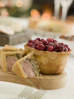 Royalty Free Photo of a Pork Turkey and Stuffing Pie Cranberry and Game Pie