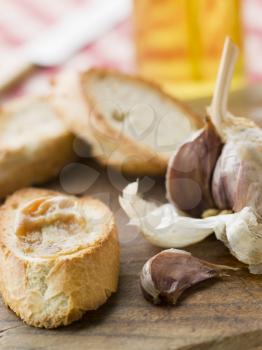 Royalty Free Photo of Cloves of Roasted Garlic Spread on Toasted Baguette