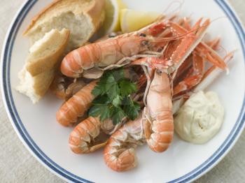 Royalty Free Photo of Langouste with Garlic Mayonnaise Lemon and Crusty baguette