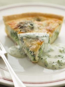 Royalty Free Photo of a Broccoli and Roquefort Quiche with Broccoli sauce