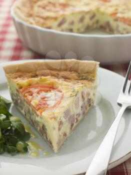 Royalty Free Photo of Quiche Lorraine with Watercress salad and Vinaigrette
