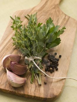 Royalty Free Photo of a Bouquet Garni Garlic Cloves and Peppercorns