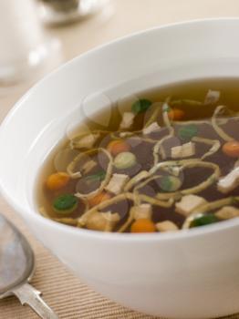 Royalty Free Photo of Chicken Consomme with Vegetable Pearls and Julienne of Pancake