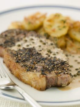 Royalty Free Photo of Steak au Poirve' with Saut Potatoes