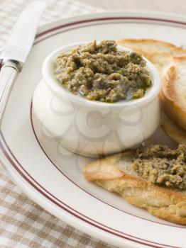 Royalty Free Photo of Green Olive Tapenade with Toasted Baguette