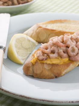 Royalty Free Photo of Rouille and Brown Shrimps on Toasted Baguette