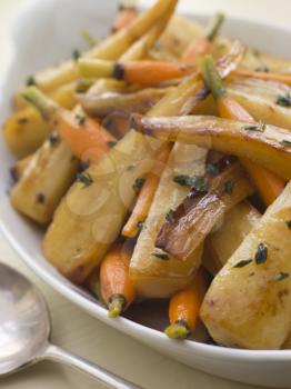 Royalty Free Photo of Parsnips and Baby Carrots Roasted in Thyme and Honey