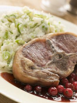 Royalty Free Photo of a Double Loin Lamb Chops with Champ and Redcurrant Jus