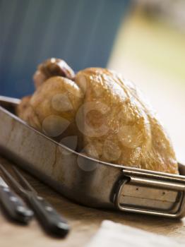 Royalty Free Photo of Roast Chicken in a Roasting Tray