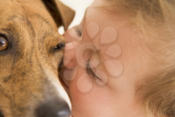 Royalty Free Photo of a Baby Kissing a Dog