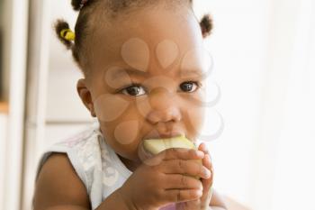 Royalty Free Photo of a Girl Eating an Apple