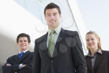 Royalty Free Photo of Three People Outside a Building