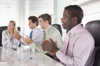 Royalty Free Photo of Four People Clapping in a Boardroom