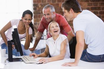 Royalty Free Photo of Four People Around a Computer