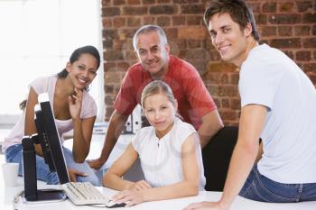 Royalty Free Photo of Four People Around a Computer