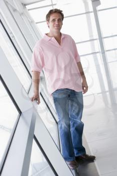 Royalty Free Photo of a Man Standing in a Corridor