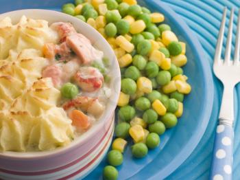 Royalty Free Photo of an Individual Fish Pie With Peas and Sweetcorn