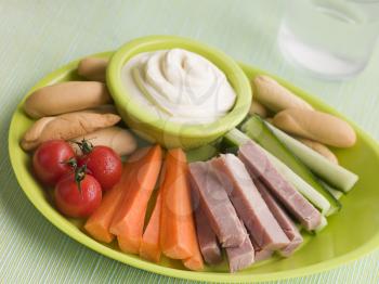 Royalty Free Photo of Ham Vegetable and Bread Sticks With Cheese Spread