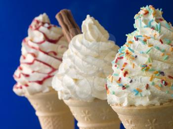 Royalty Free Photo of Whipped Ice Cream Cones With Three Different Toppings
