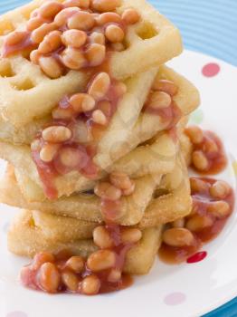 Royalty Free Photo of a Stack of Potato Waffles With Baked Beans