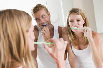 Royalty Free Photo of a Couple Brushing Their Teeth