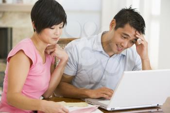 Royalty Free Photo of a Couple Looking Unhappy at the Laptop