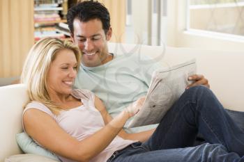 Royalty Free Photo of a Couple Reading a Newspaper