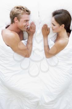 Royalty Free Photo of a Couple in Bed Smiling