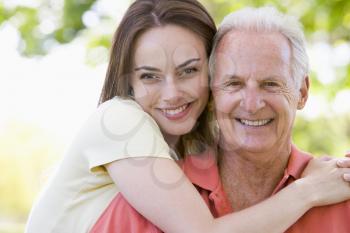 Royalty Free Photo of a Girl Hugging an Older Man