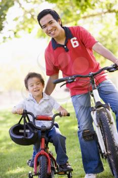 Royalty Free Photo of a Man and Boy on Bikes