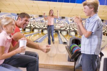 Royalty Free Photo of a Family at a Bowling Alley Cheering