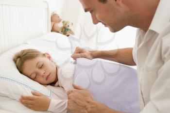 Royalty Free Photo of a Man Waking His Daughter