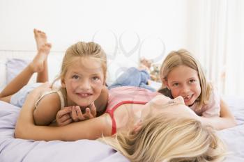 Royalty Free Photo of a Mother and Two Daughters in Bed