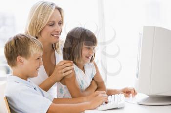 Royalty Free Photo of a Woman and Children at the Computer