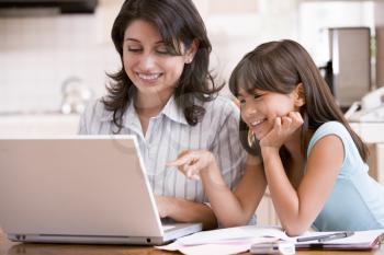 Royalty Free Photo of a Woman and Her Daughter at a Computer