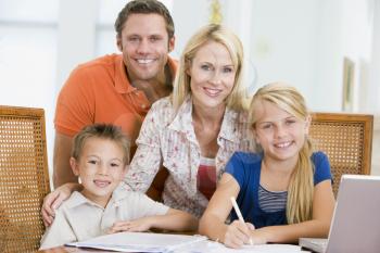 Royalty Free Photo of a Couple Helping Their Children With Homework