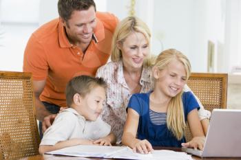 Royalty Free Photo of a Couple Helping Their Children With Homework
