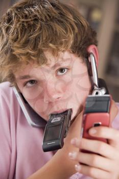 Royalty Free Photo of a Boy With Several Cellphones