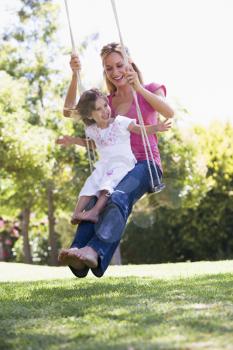 Royalty Free Photo of a Mother and Daughter on a Swing