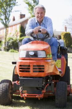 Royalty Free Photo of a Man on a Riding Mower