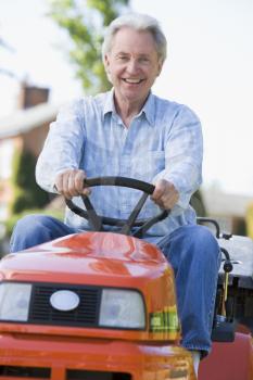 Royalty Free Photo of a Man With a Riding Lawn Mower